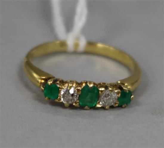 An emerald and diamond five-stone ring, 18ct gold shank, size L.